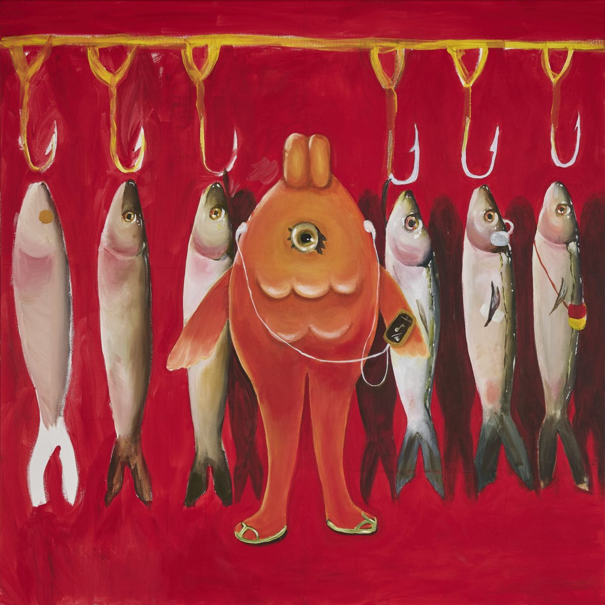 Ceramic rings in soft neutral tones suspended by string in a minimalist hanging installation against a white wall.