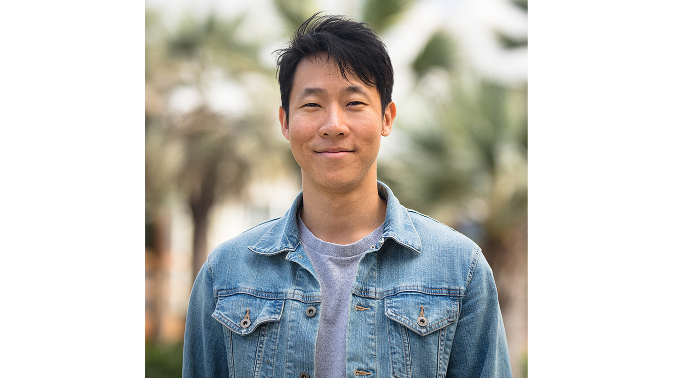 Marcus Yuen profile picture. He wears a denim jacket in front of out of focus palm trees.